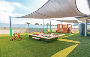 Childcare Outdoor Area with play equipment and sandpit