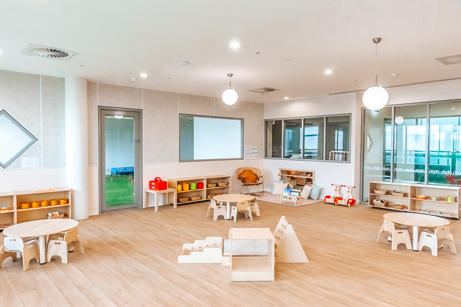 Childcare infant classroom with Montessori materials and climbing frame