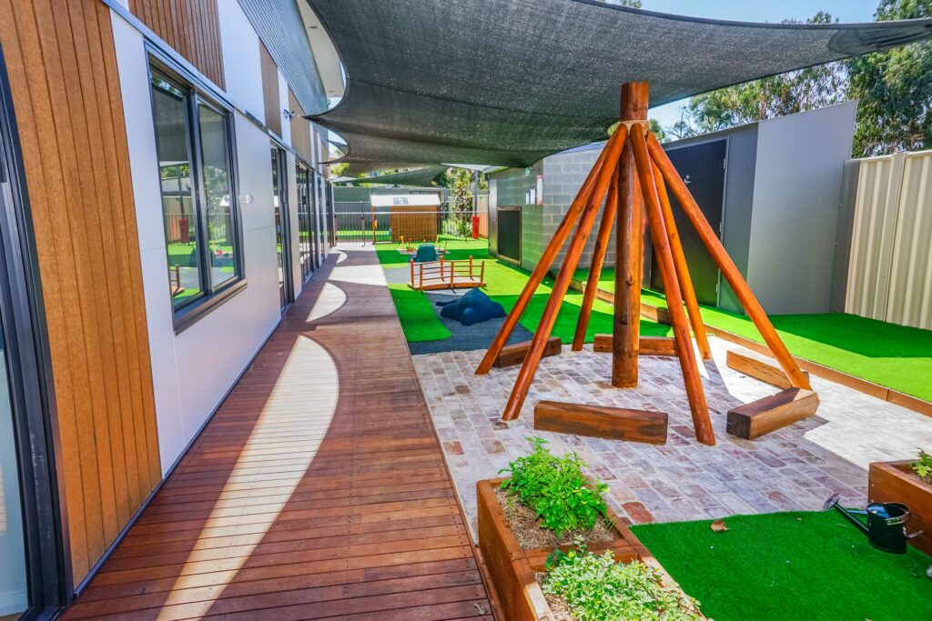 Outdoor area with garden beds and teepee
