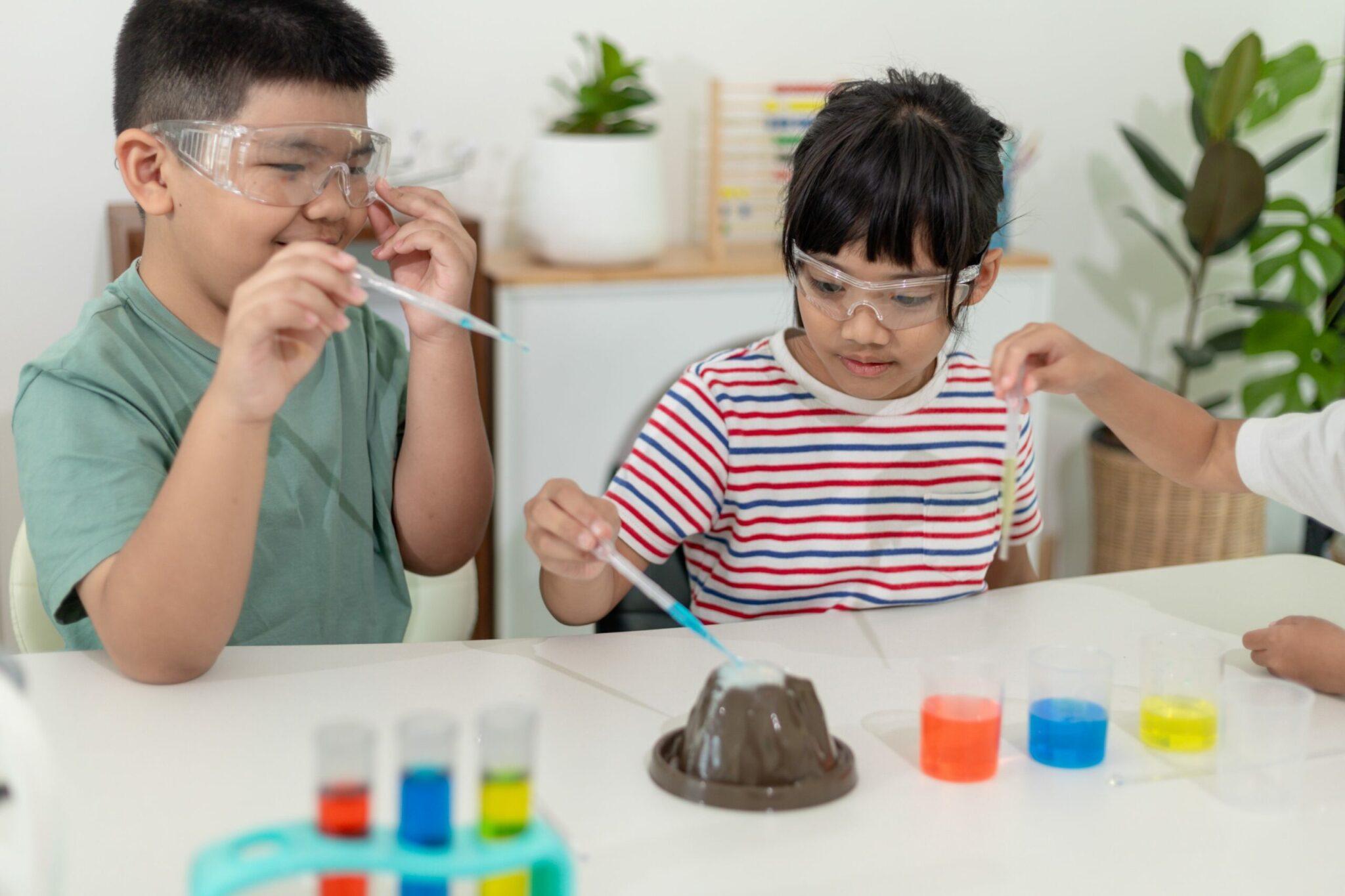 2 children working on a science experiment erupting volcano