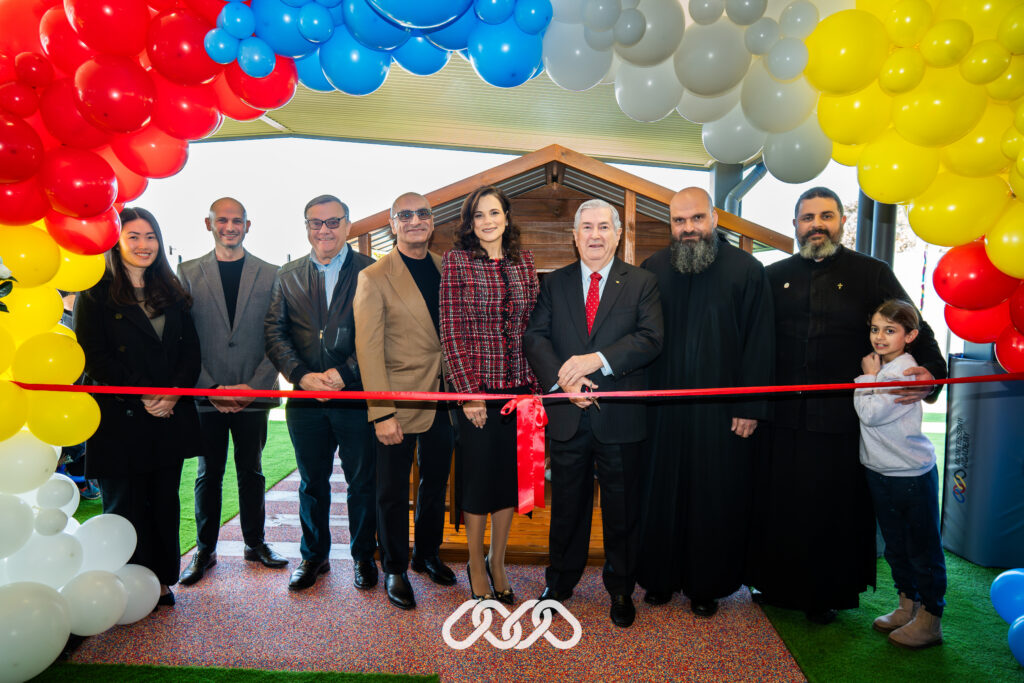 Senior community leaders stand together under balloon arch at the grand opening of a Montessori childcare centre in St Marys, NSW.