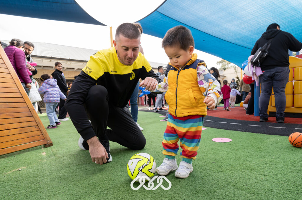 Child playing soccer at outdoors at the Auburn Montessori Academy open day with IFA Sports