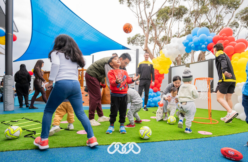 Children enjoy basket ball and soccer activities outdoors at Bexley Montessori Grand Opening.
