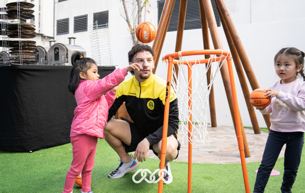 Children playing basketball at outdoors at the Entrada Montessori Academy open day with IFA Sports