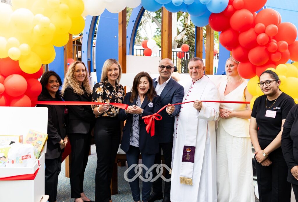 Senior community leaders stand together under balloon arch at the grand opening of a Montessori childcare centre in Winston Hills, NSW.