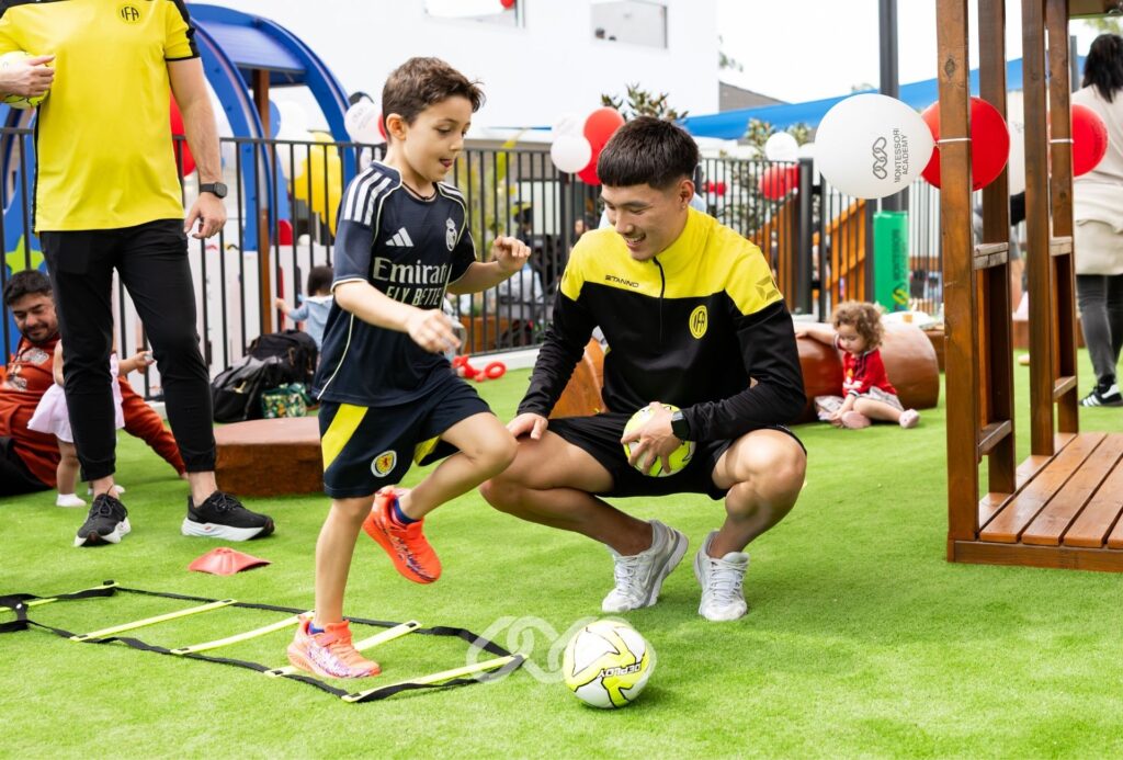 Children enjoy running through a ladder and soccer activities outdoors at Winston Hills Montessori Grand Opening.