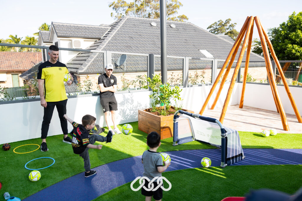 Children enjoy soccer activities outdoors at Penrith Derby Street Montessori Grand Opening.